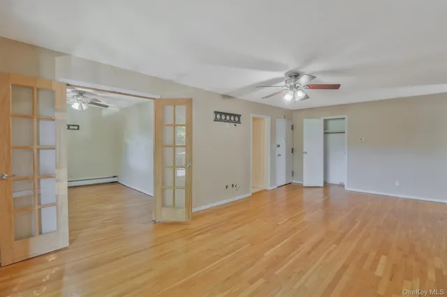 a view of an empty room with a fan