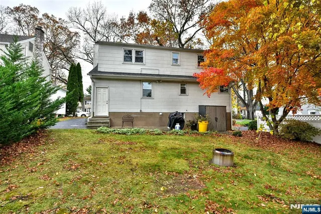 a backyard of a house with table and chairs