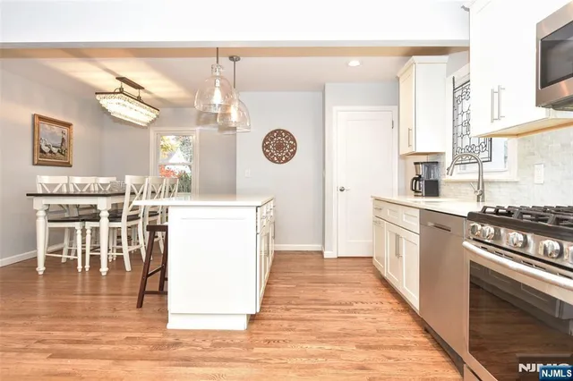 a kitchen with a stove a refrigerator and a dining table
