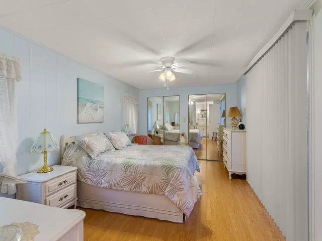 a spacious bedroom with a bed and a chandelier