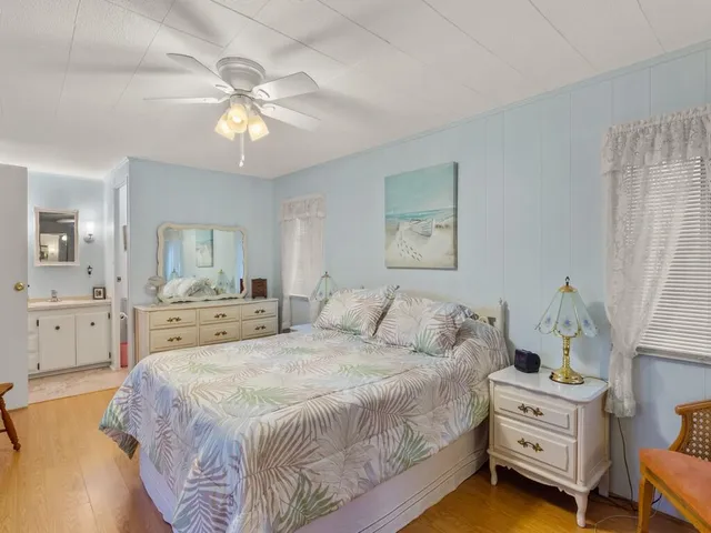 a spacious bedroom with a bed and a chandelier