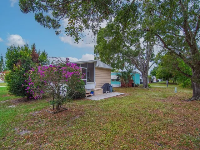a view of a backyard with garden and trees
