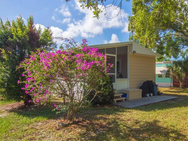 a view of a house with a backyard and sitting area
