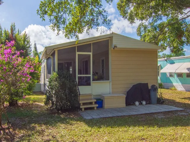 a view of house with swimming pool and porch with furniture