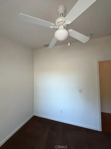 an empty room with a fan