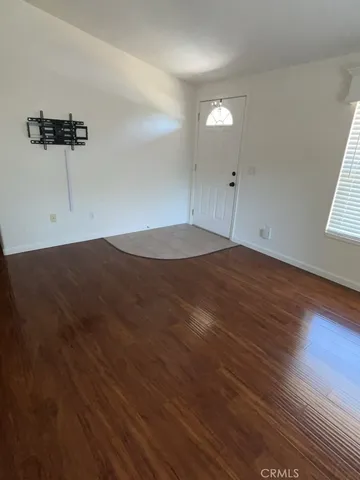 a view of a room with wooden floor and windows