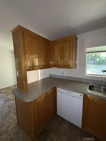 a kitchen with stainless steel appliances granite countertop a sink a stove and a microwave