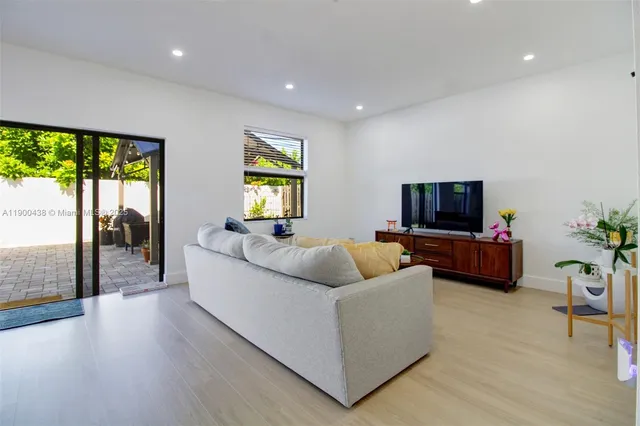 a view of a backyard with a small deck and a garden