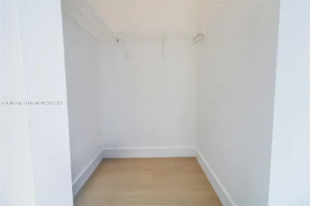 a white toilet sitting next to a white tub