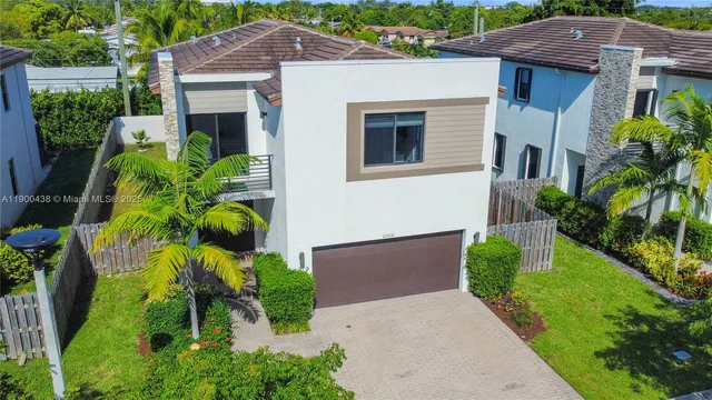 a aerial view of a house with a yard and potted plants