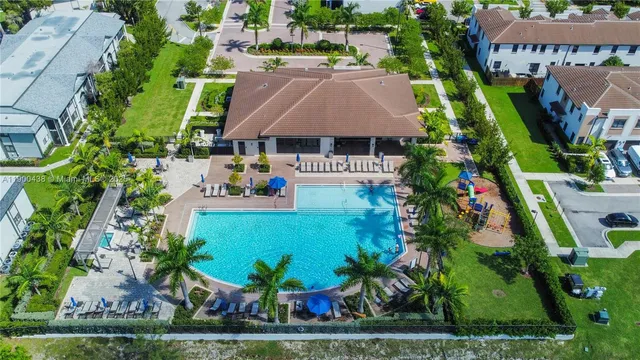 a front view of a house with a yard and potted plants