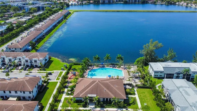 a front view of a house with a yard and potted plants
