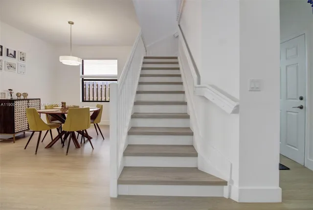 a view of entryway and hall with wooden floor