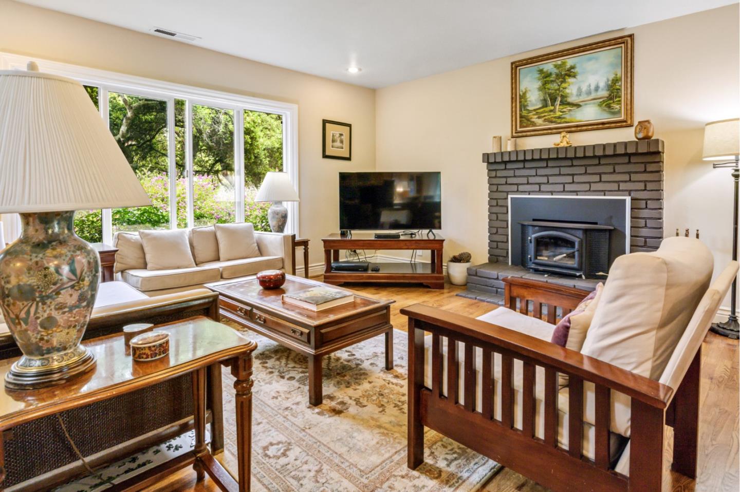 17752 Vierra Canyon Road Salinas, CA 93907 - Photo 6 of 31 a living room with furniture a flat screen tv and a fireplace