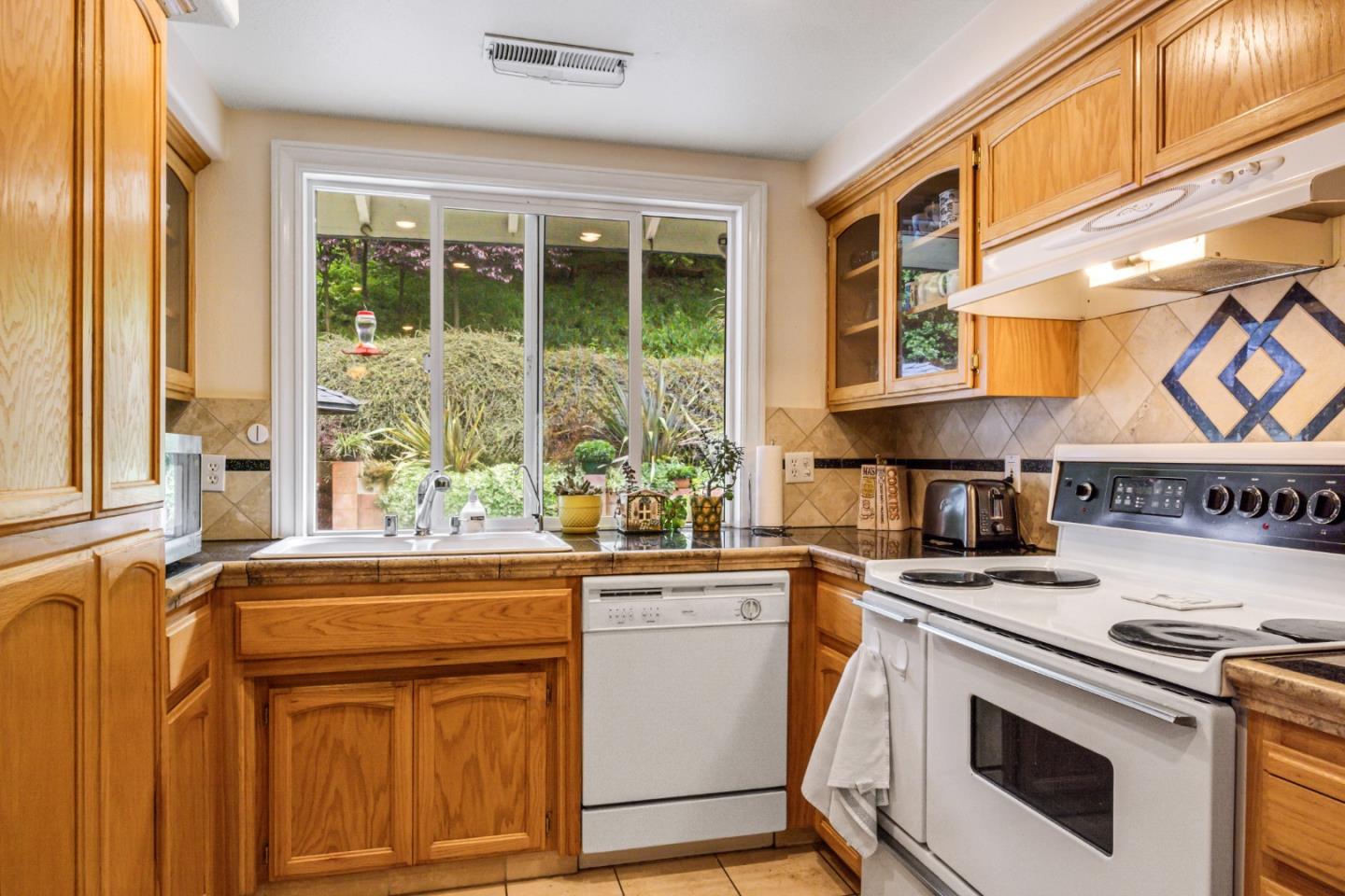 17752 Vierra Canyon Road Salinas, CA 93907 - Photo 9 of 31 a kitchen with stainless steel appliances granite countertop a stove and a sink
