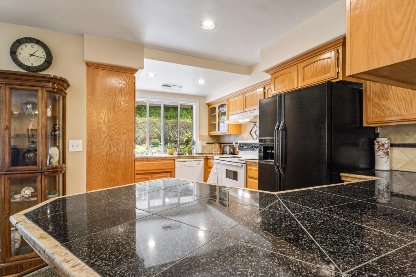 17752 Vierra Canyon Road Salinas, CA 93907 - Photo 10 of 31 a kitchen with stainless steel appliances granite countertop a refrigerator a stove and a sink with granite countertops