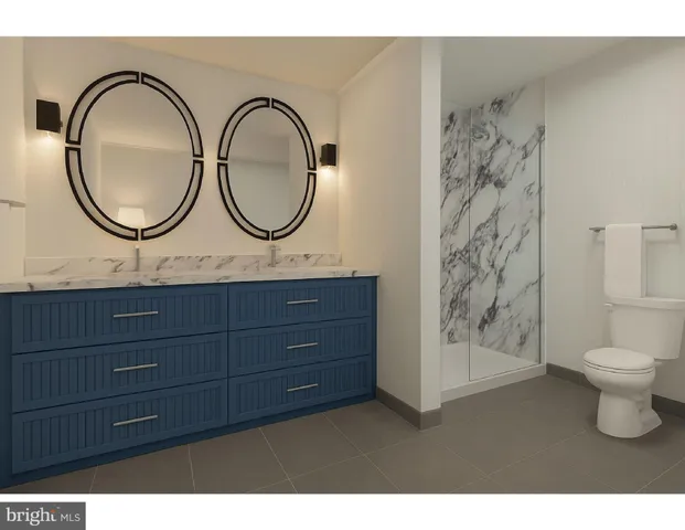 a bathroom with a toilet a sink and a mirror