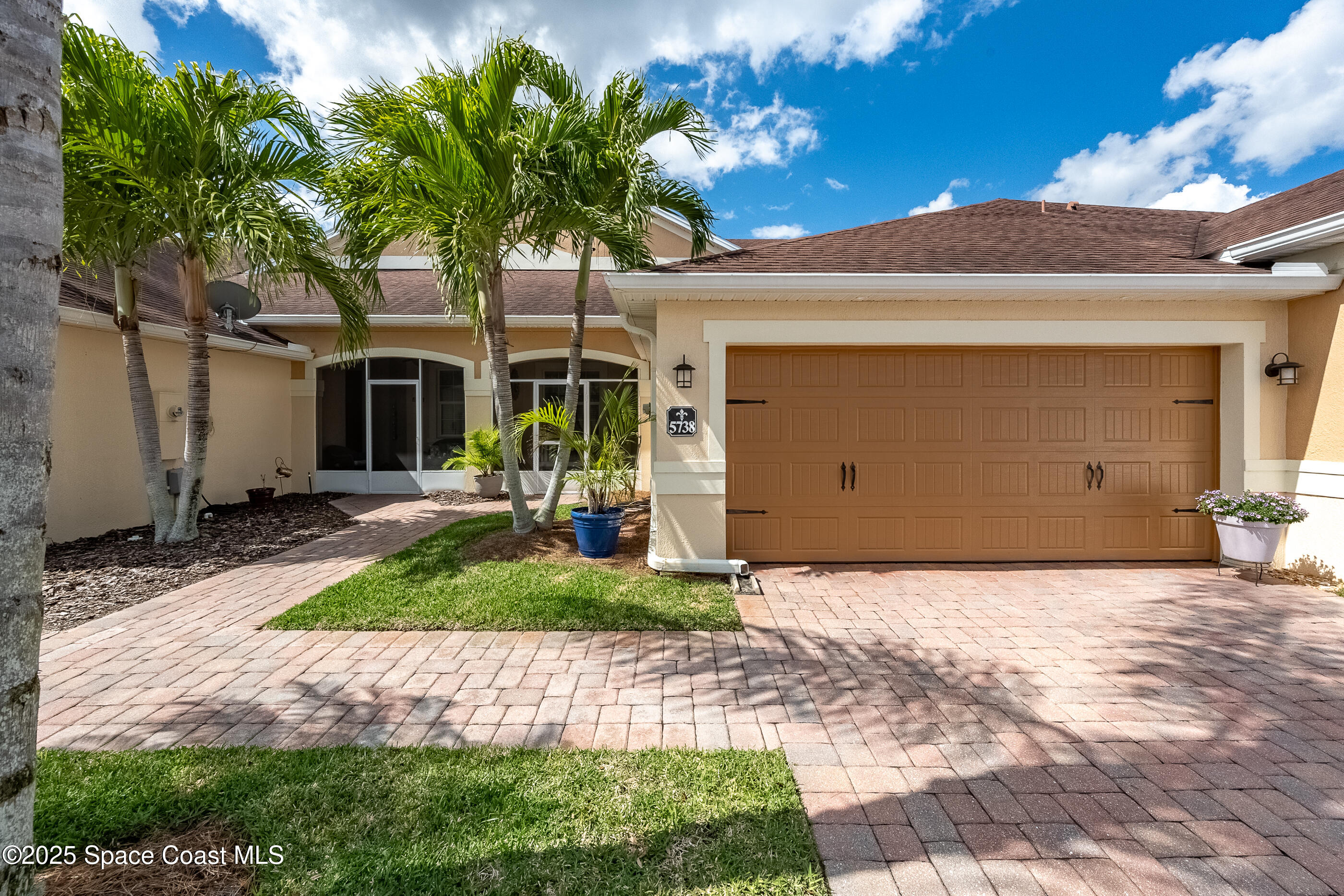 5738 Tamarac Drive Melbourne, FL 32940 - Photo 1 of 27 a front view of a house with garden