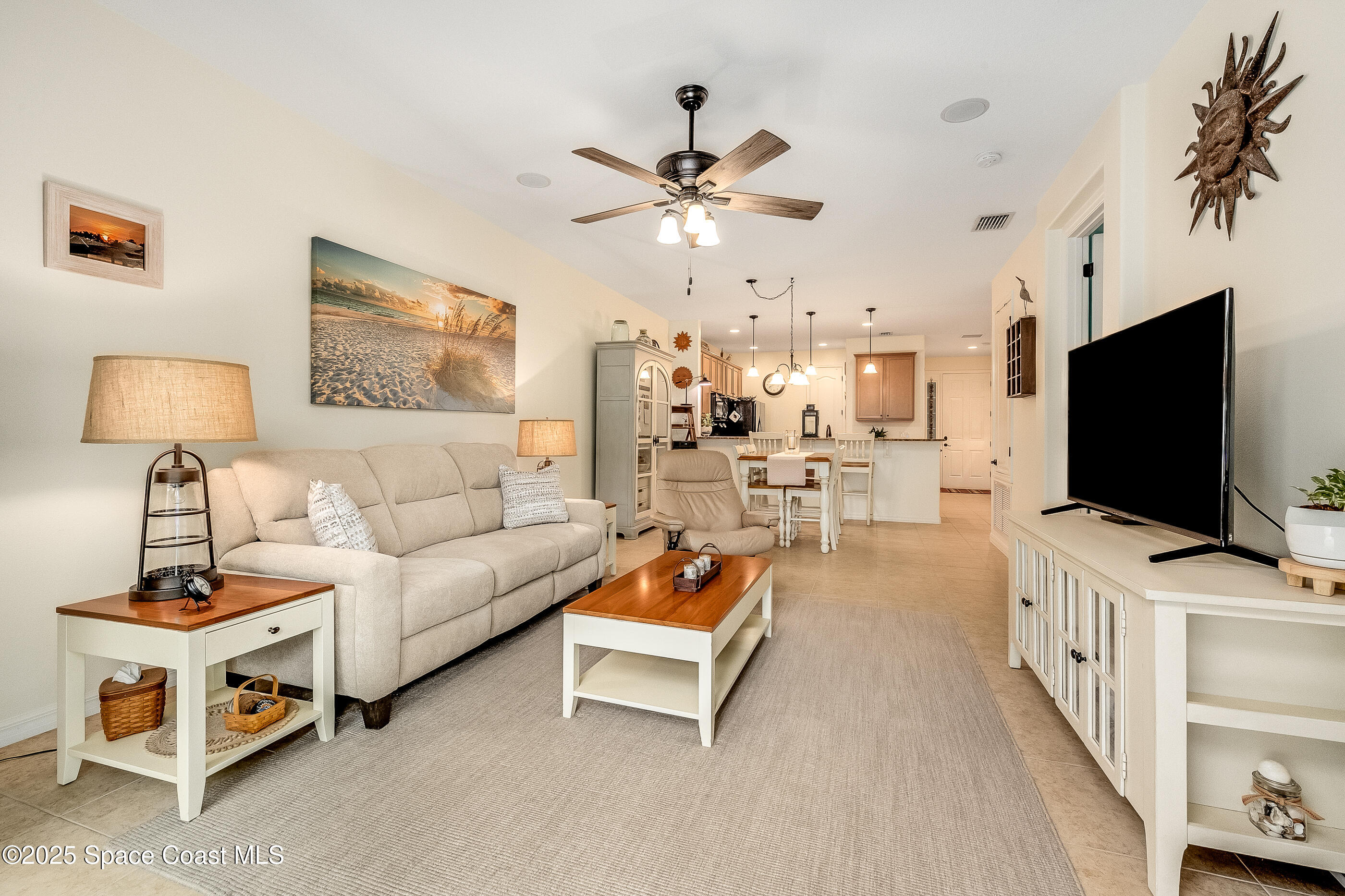 5738 Tamarac Drive Melbourne, FL 32940 - Photo 12 of 27 a living room with furniture and a flat screen tv