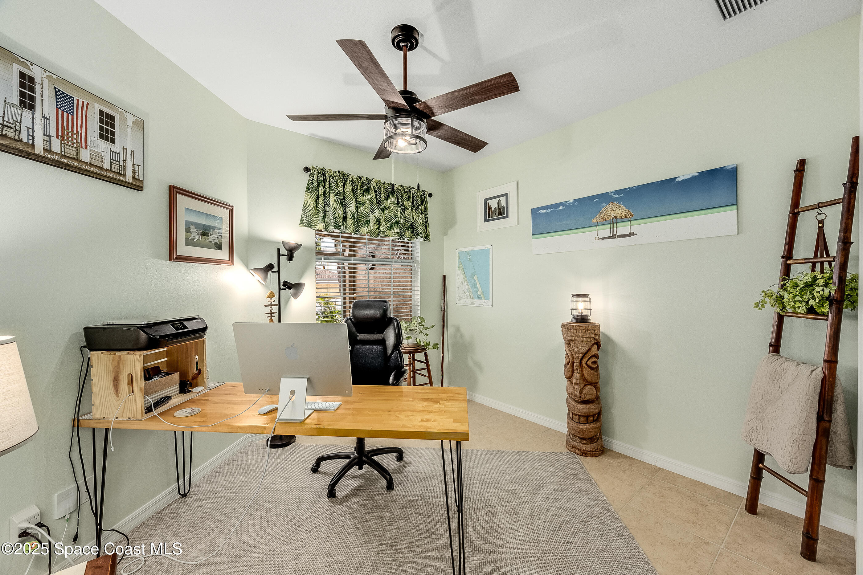 5738 Tamarac Drive Melbourne, FL 32940 - Photo 19 of 27 a room with furniture a rug and a ceiling fan