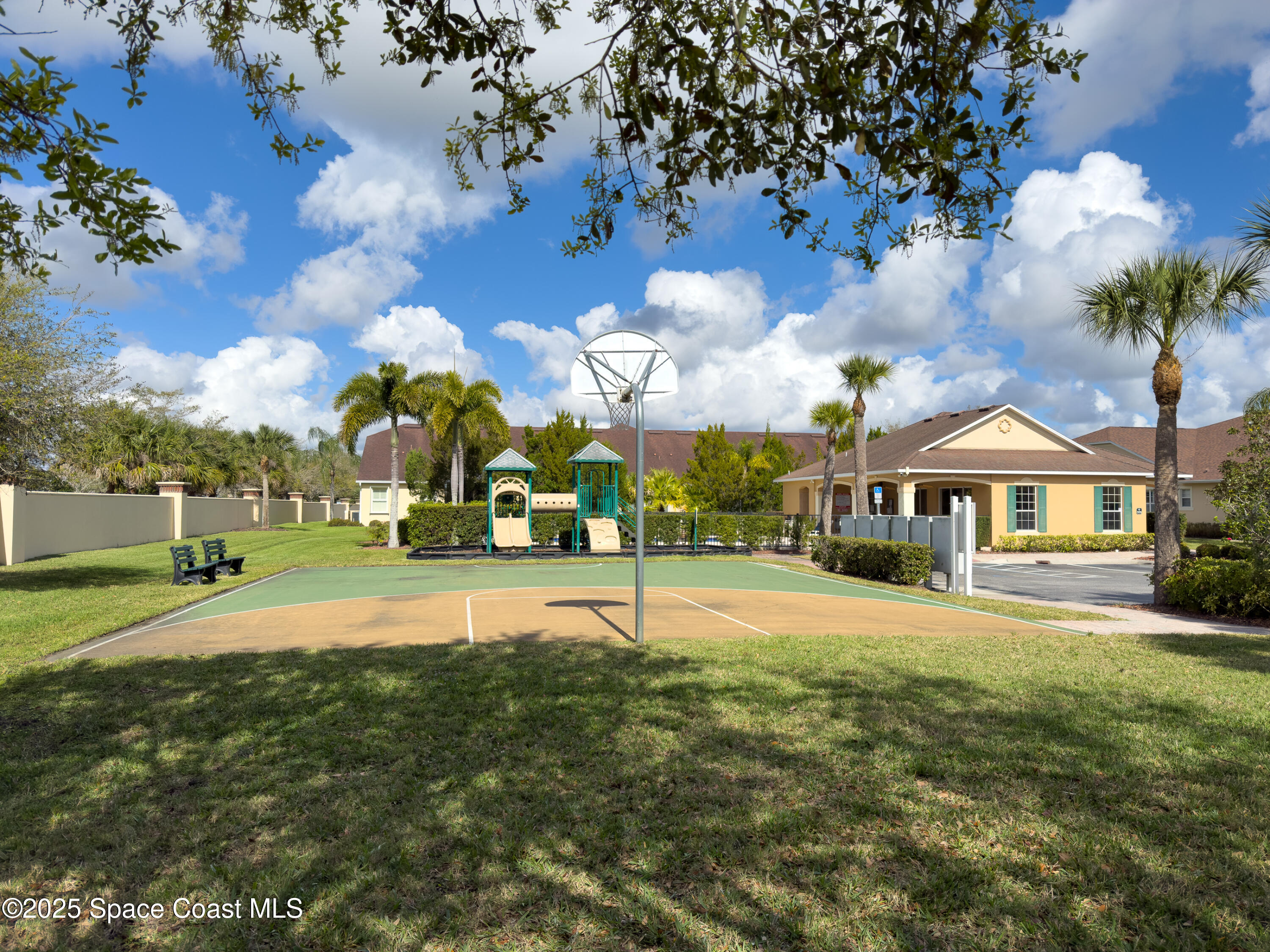 5738 Tamarac Drive Melbourne, FL 32940 - Photo 25 of 27 a view of a white house with a big yard and potted plants