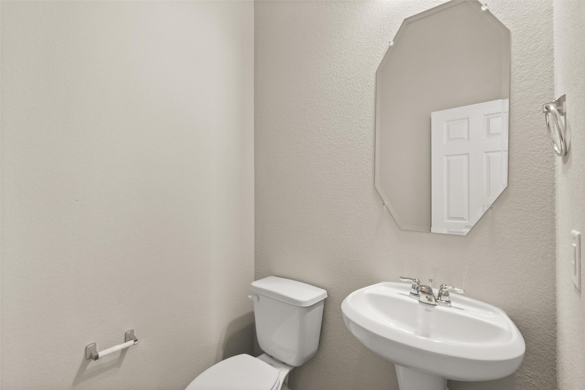 313 Redbud Rdg Drive Brookshire, TX 77423 - Photo 4 of 32 a bathroom with a sink mirror and toilet