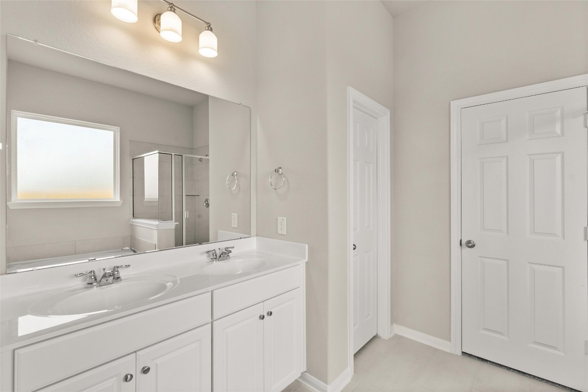 313 Redbud Rdg Drive Brookshire, TX 77423 - Photo 10 of 32 a bathroom with a double vanity sink and mirror