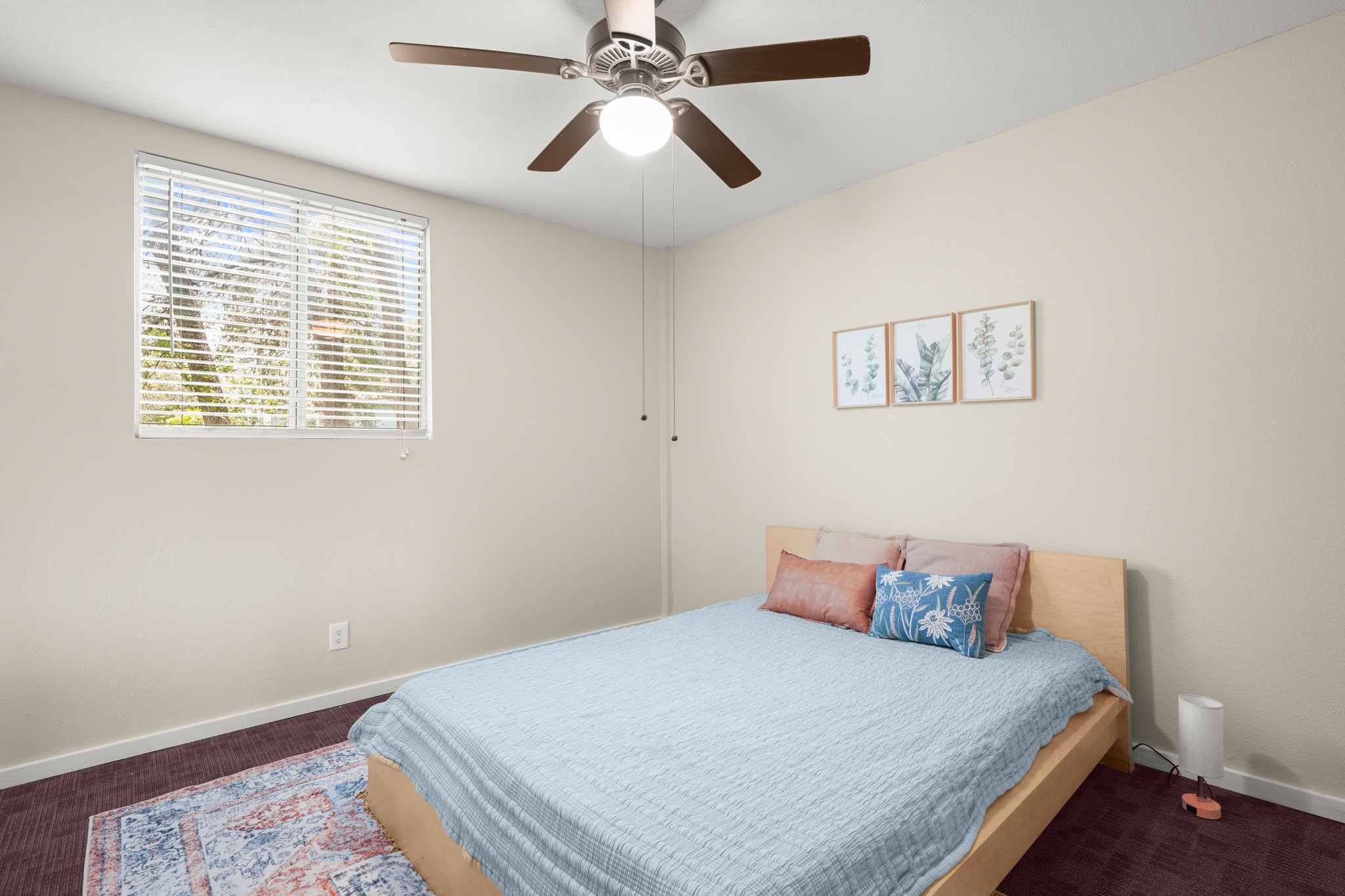 9725 Bock Road Buda, TX 78610 - Photo 15 of 32 A window-filled room with a cozy bed and a ceiling fan for comfort.