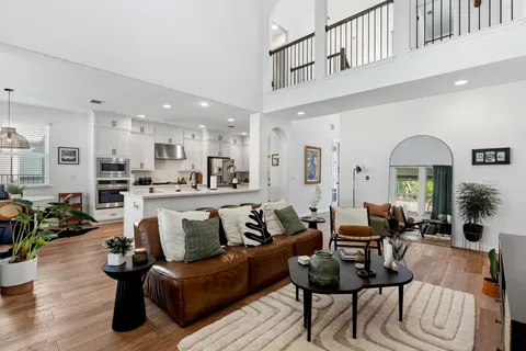 a living room with furniture or kitchen view and a table