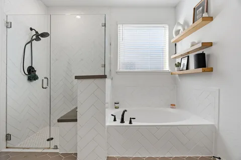 a bathroom with a bathtub and a shower