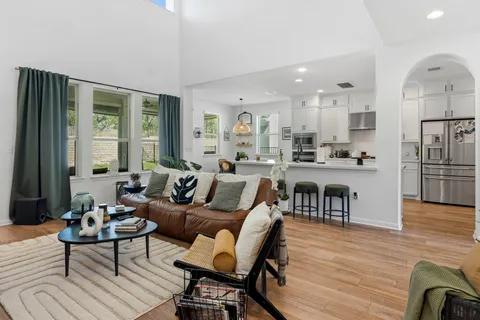 a living room with furniture and a wooden floor