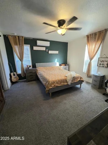 a bedroom with a bed and a flat tv screen