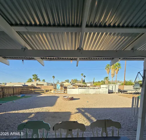 a room with pool table and chairs