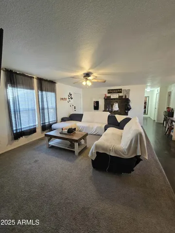 a living room with furniture a window and dresser