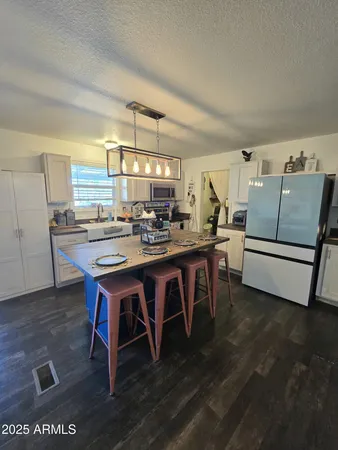 a dining room with a wooden table and chairs