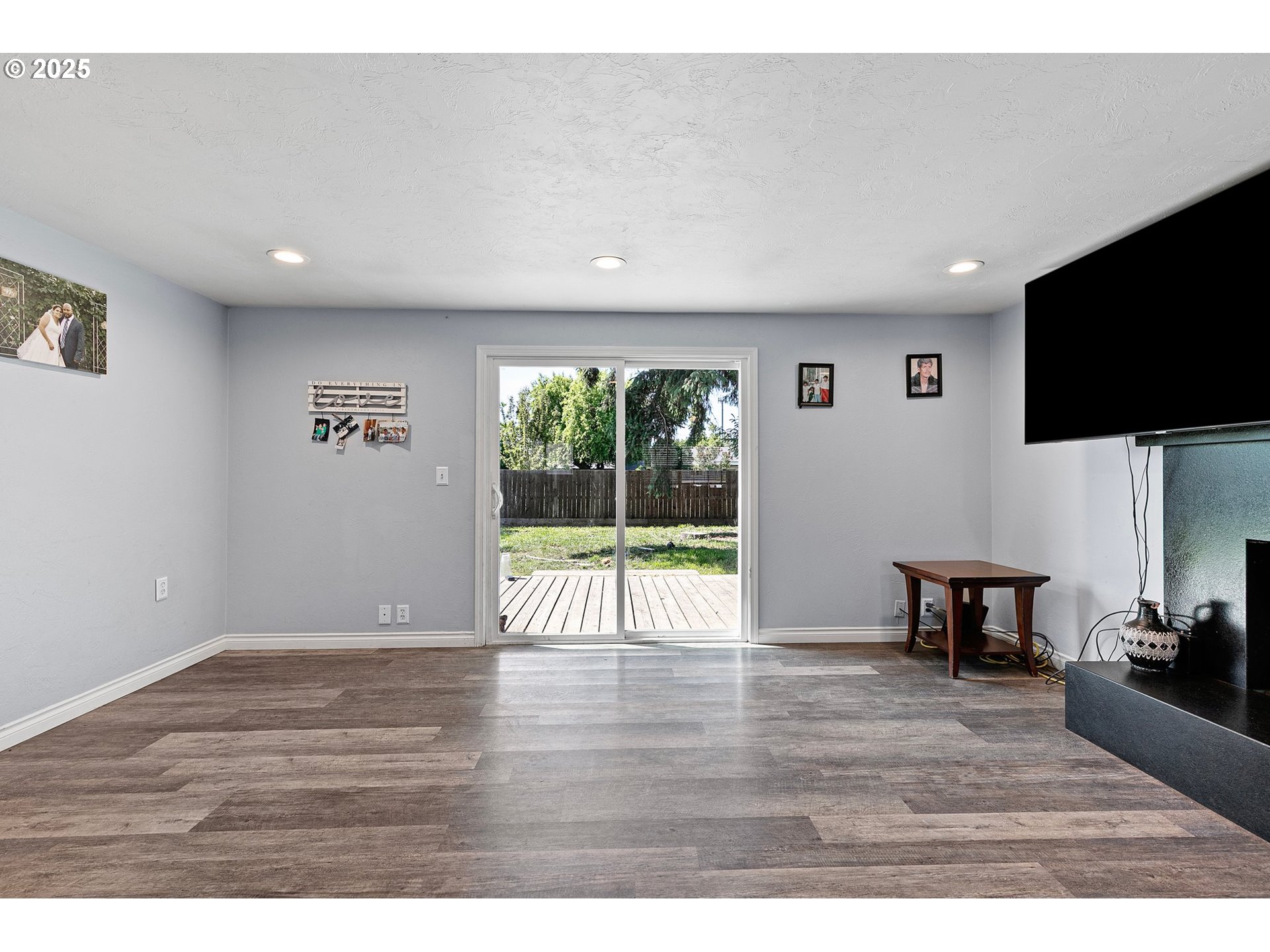 1221 Kenray Loop Springfield, OR 97477 - Photo 3 of 19 a view of a livingroom with furniture a flat screen tv and wooden floor