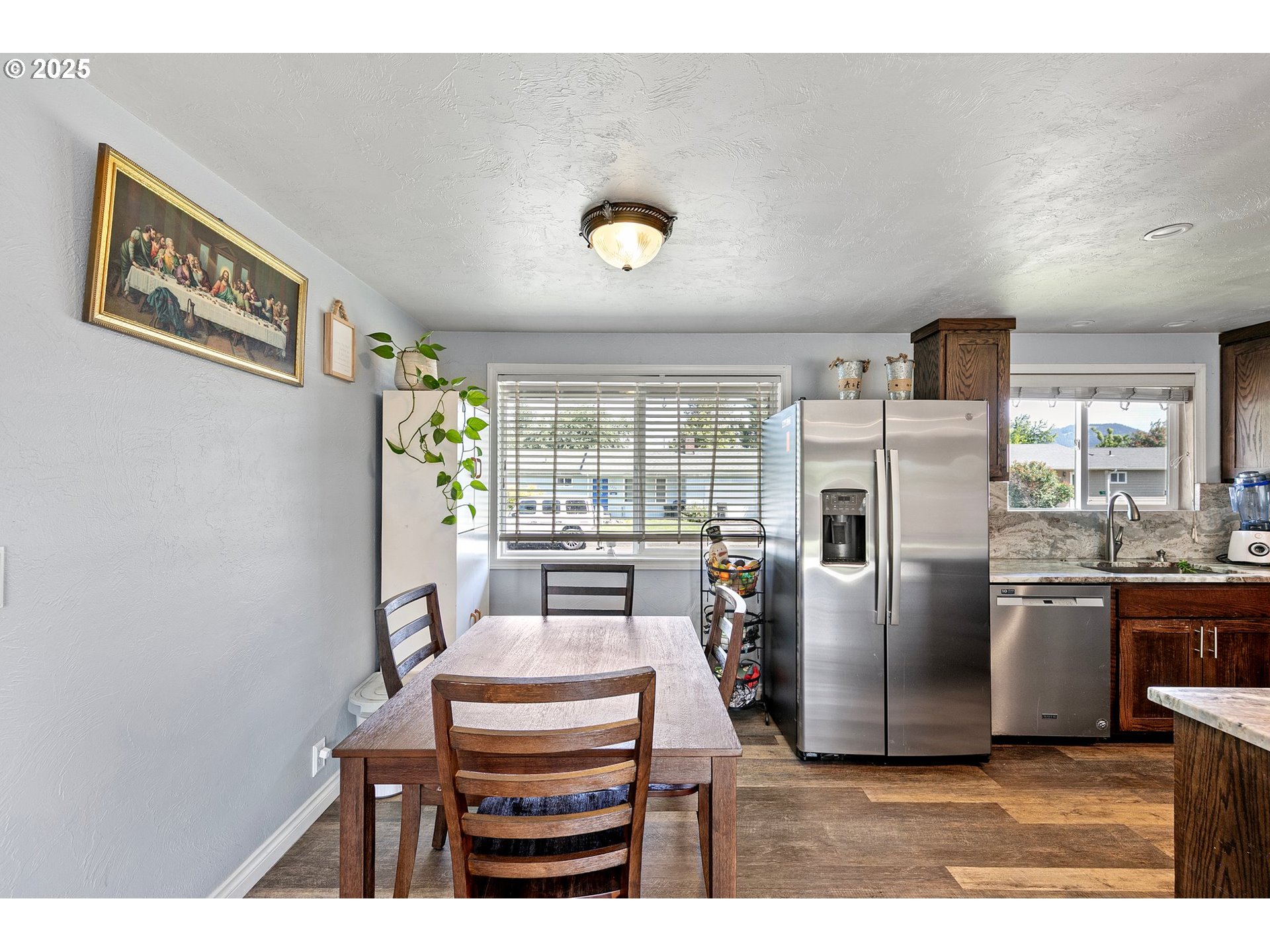 1221 Kenray Loop Springfield, OR 97477 - Photo 9 of 19 a dining room with kitchen view wooden floor and large window