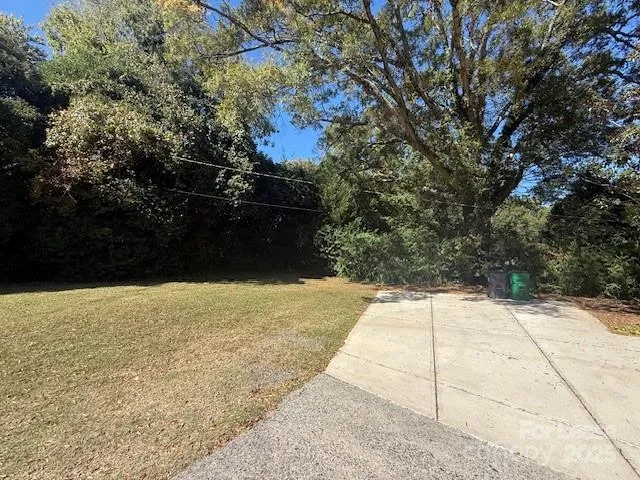 a front view of a house with a yard covered with snow