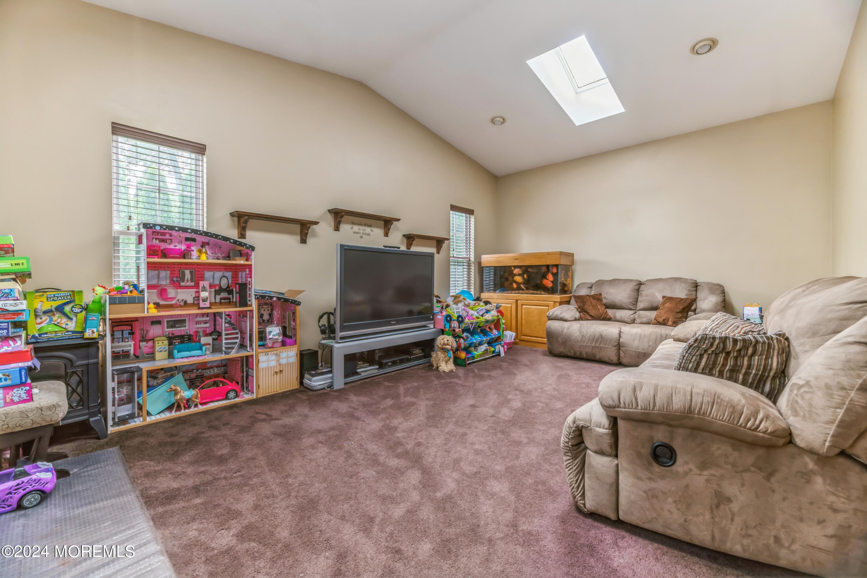 95 Nutmeg Road Aberdeen, NJ 07747 - Photo 12 of 21 a living room with furniture a flat screen tv and a couch