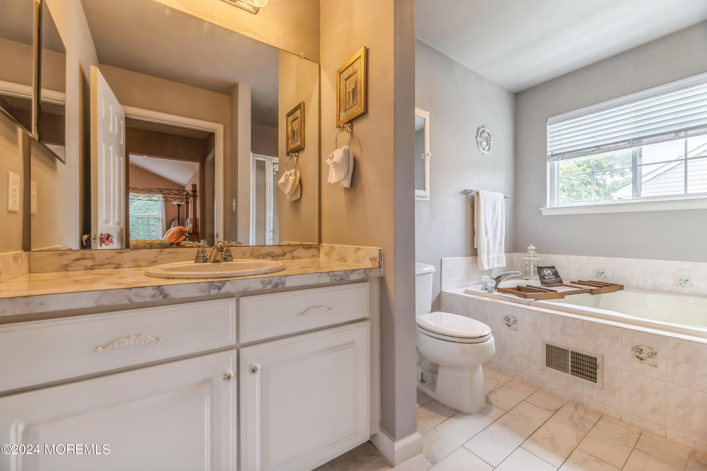 95 Nutmeg Road Aberdeen, NJ 07747 - Photo 15 of 21 a bathroom with a granite countertop sink mirror and a toilet