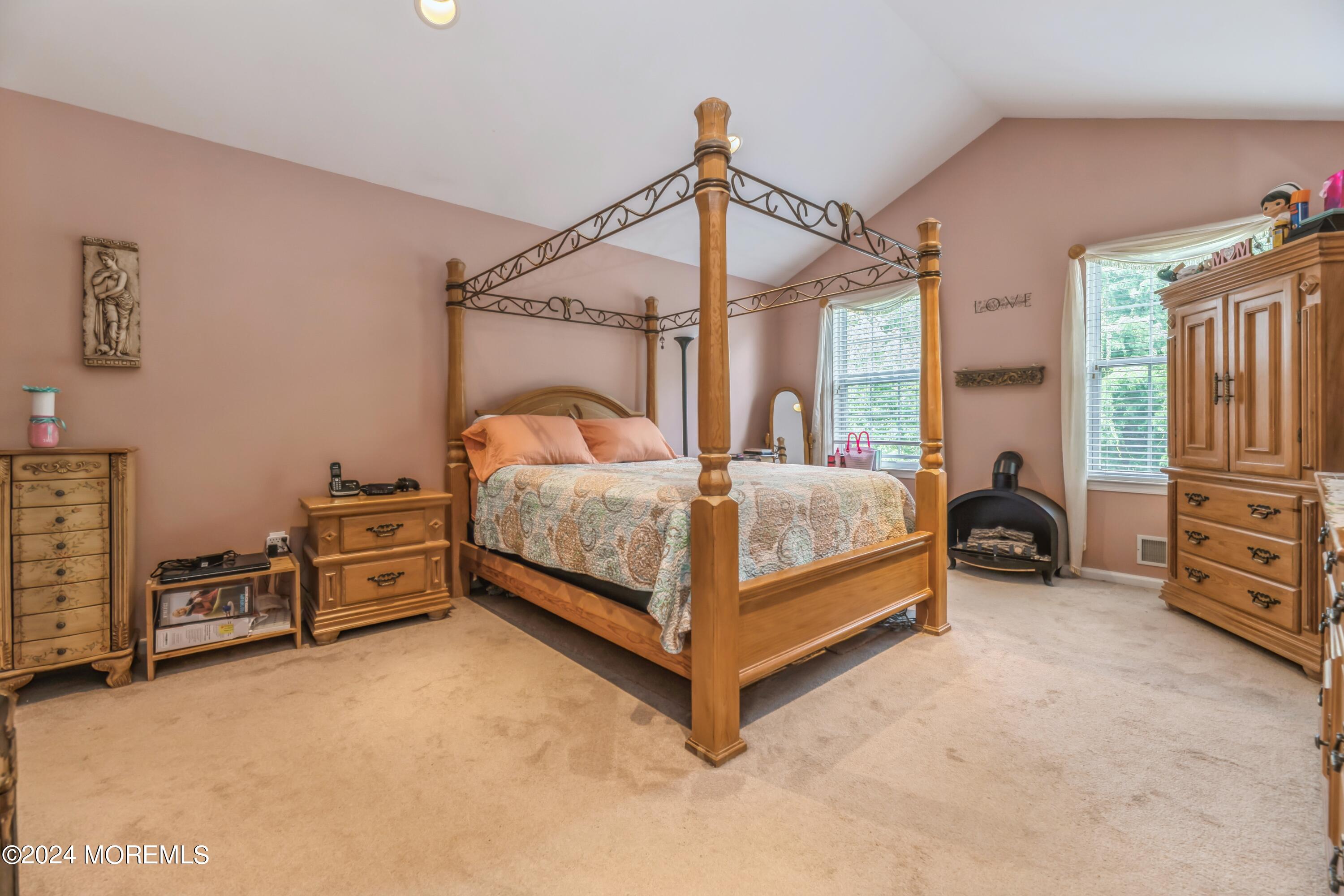 95 Nutmeg Road Aberdeen, NJ 07747 - Photo 16 of 21 a bedroom with a bed and a chandelier