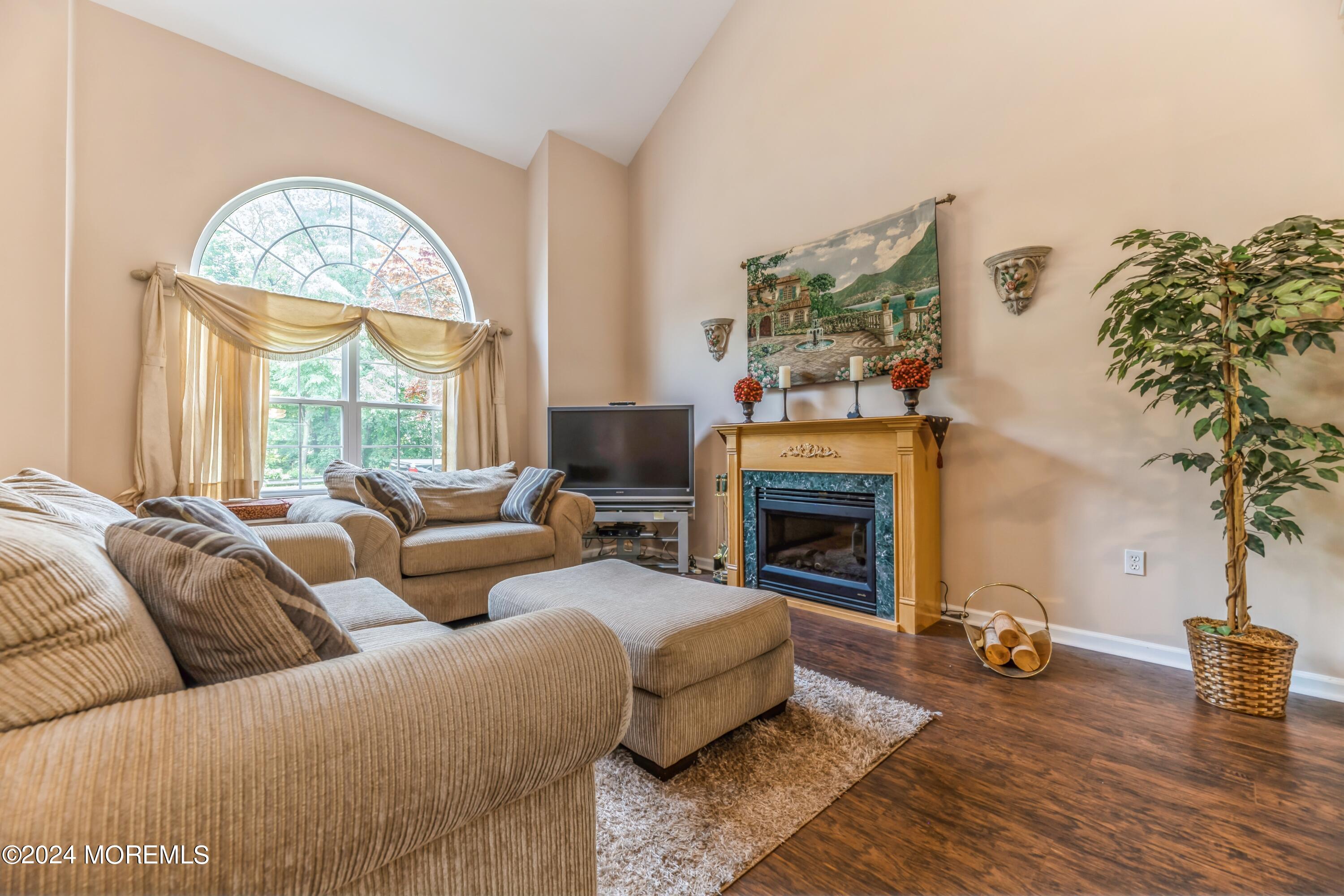95 Nutmeg Road Aberdeen, NJ 07747 - Photo 4 of 21 a living room with furniture a fireplace and a large mirror