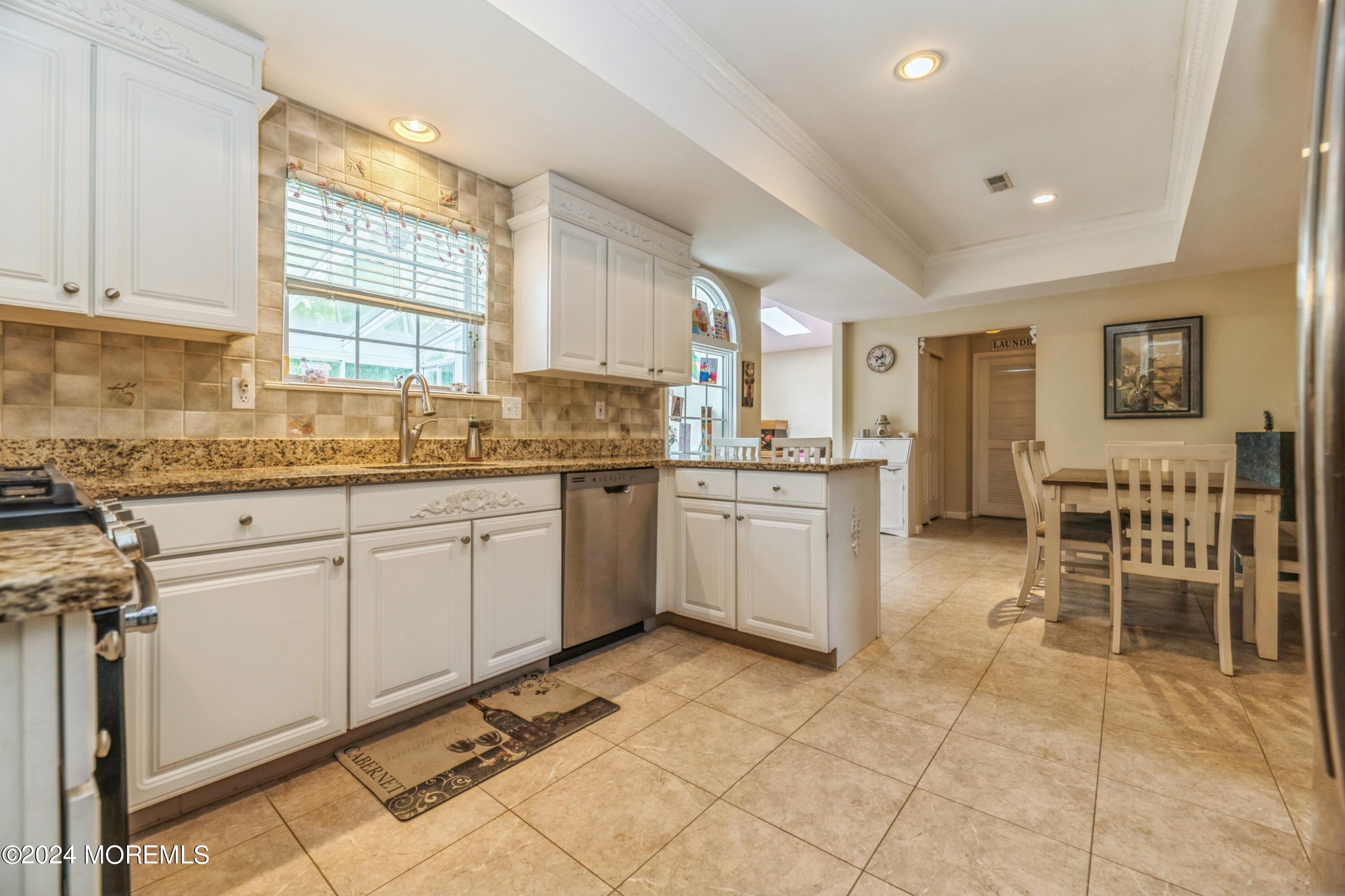 95 Nutmeg Road Aberdeen, NJ 07747 - Photo 6 of 21 a kitchen with a sink window and cabinets
