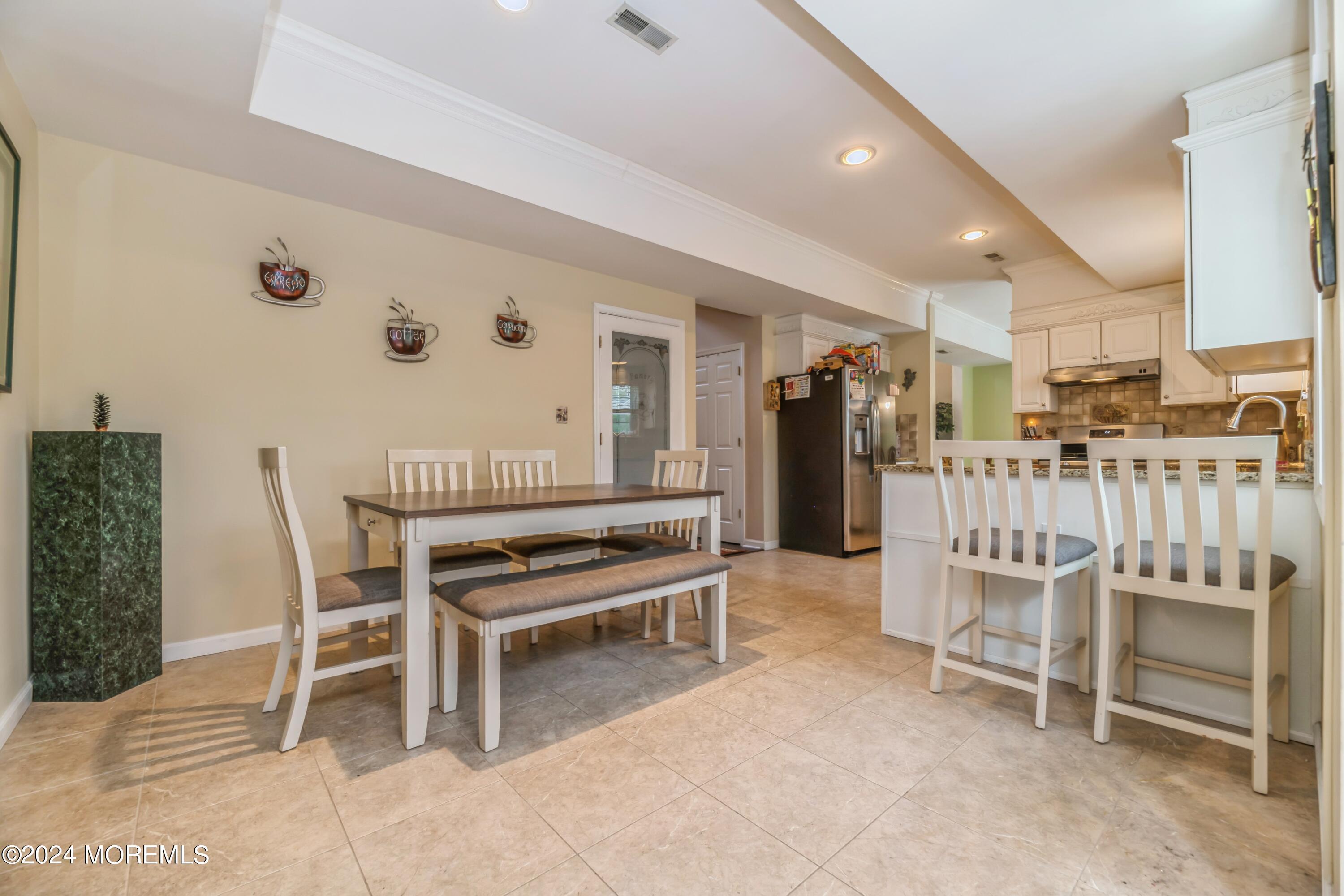 95 Nutmeg Road Aberdeen, NJ 07747 - Photo 8 of 21 a dining room with furniture and entryway