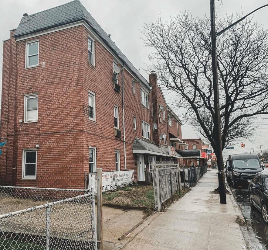 110-15 Rockaway Boulevard Queens, NY 11420 - Photo 1 of 10 a pathway of a house with a large tree
