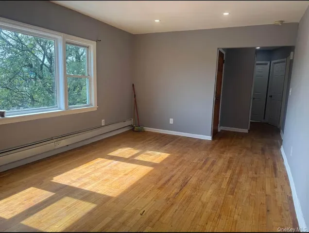 a view of room with window and hardwood floor
