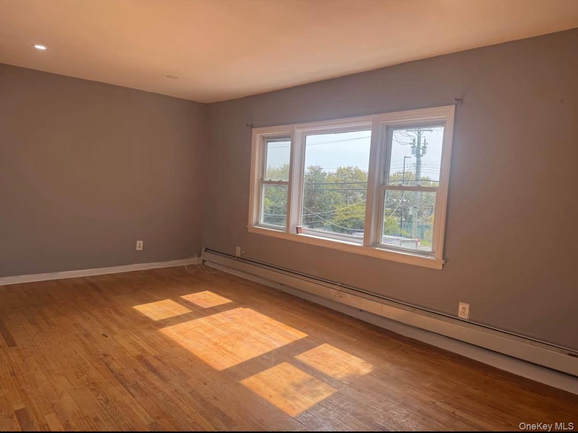 110-15 Rockaway Boulevard Queens, NY 11420 - Photo 4 of 10 a view of an empty room with a window