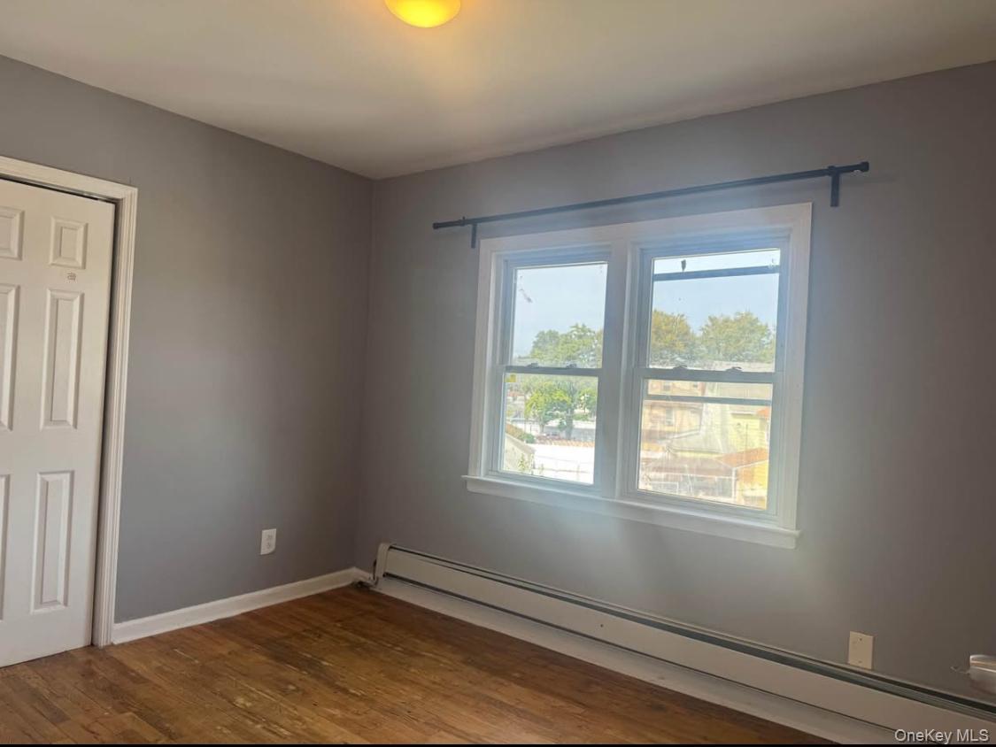 110-15 Rockaway Boulevard Queens, NY 11420 - Photo 5 of 10 an empty room with windows