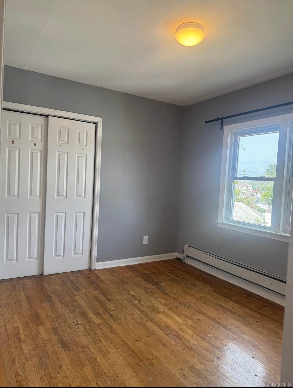 110-15 Rockaway Boulevard Queens, NY 11420 - Photo 8 of 10 an empty room with a window