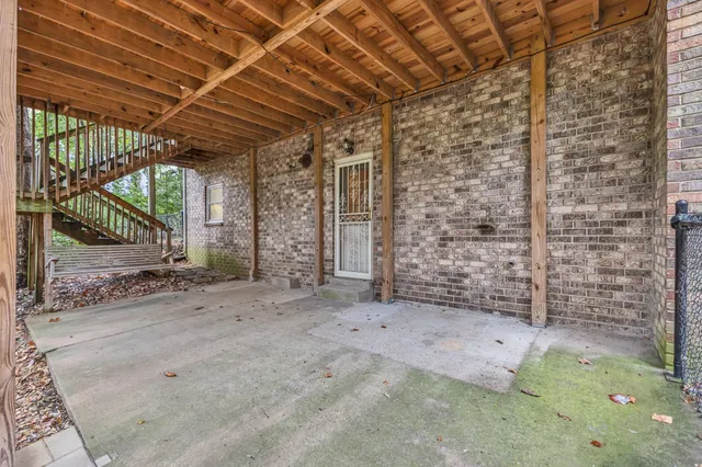 a view of a patio with table and chairs